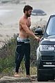 liam hemsworth bares his ripped abs while stripping out of wetsuit 38