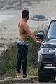 liam hemsworth bares his ripped abs while stripping out of wetsuit 39