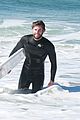 liam hemsworth and brother luke show off their wetsuit bods at the beach 04