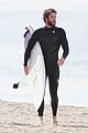 liam hemsworth flaunts his toned wetsuit bod while surfing see his wipeout pic 01