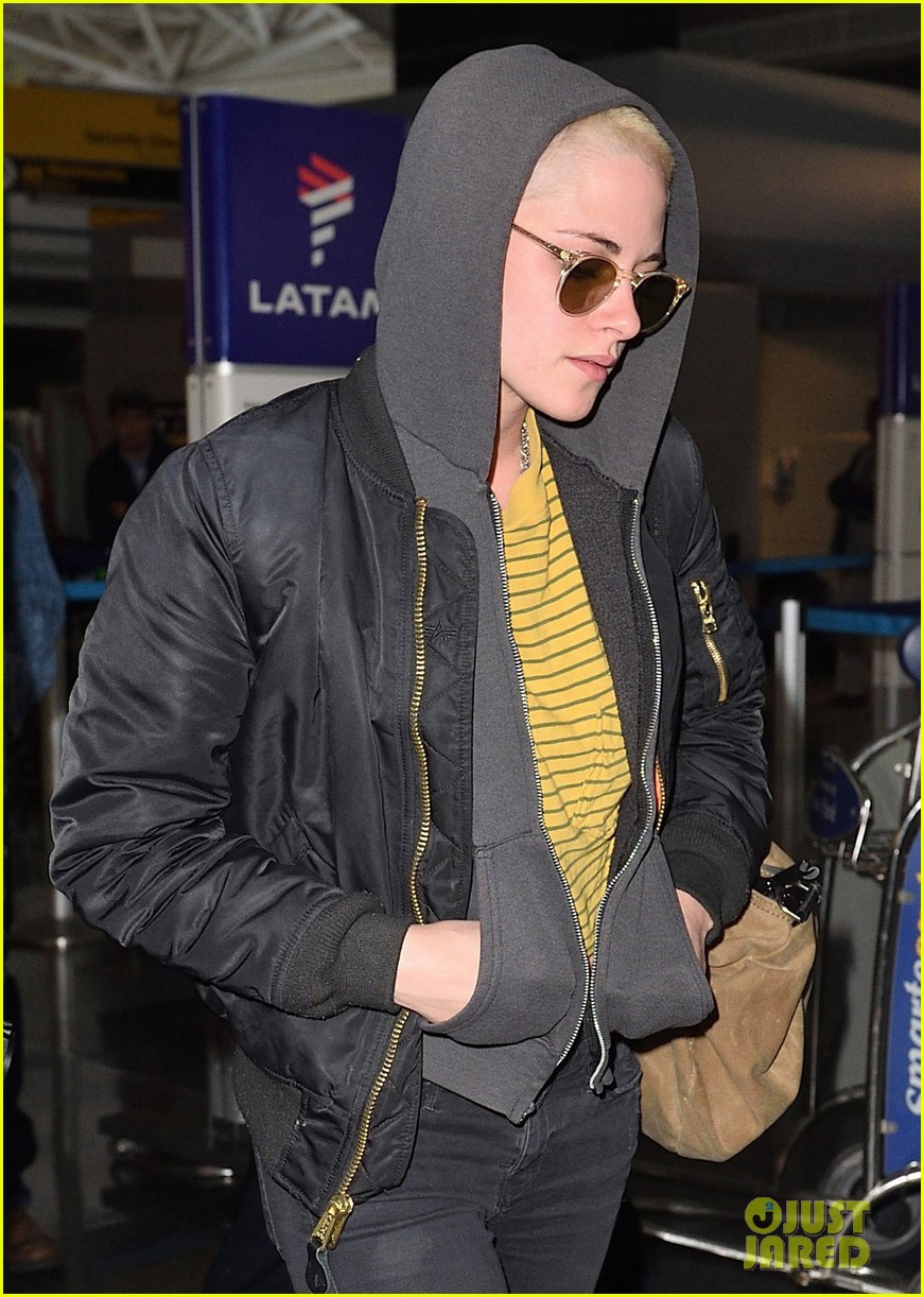 kristen stewart covers up new buzzed hair arriving in nyc 04