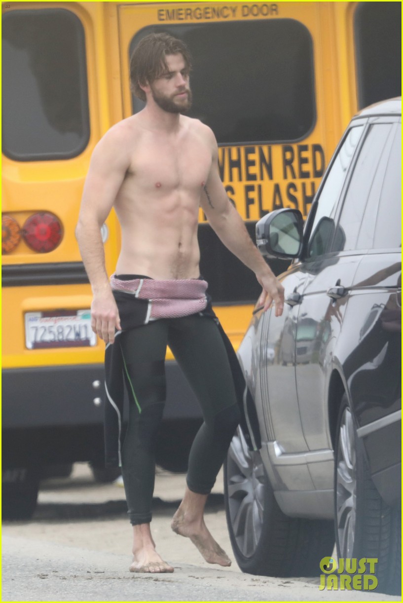 liam hemsworth strips out of wetsuit to reveal ripped abs 03