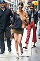 kendall jenner shows off her legs in olive green skirt and oversized sweatshirt 01