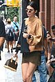 kendall jenner shows off her legs in olive green skirt and oversized sweatshirt 02