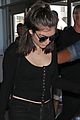 lorde keeps her head low for her flight out of town 01