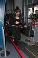lorde keeps her head low for her flight out of town 10