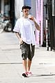 justin bieber walks by wings wall portrait at perfect time 02