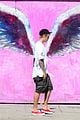 justin bieber walks by wings wall portrait at perfect time 03