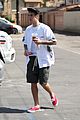 justin bieber walks by wings wall portrait at perfect time 05