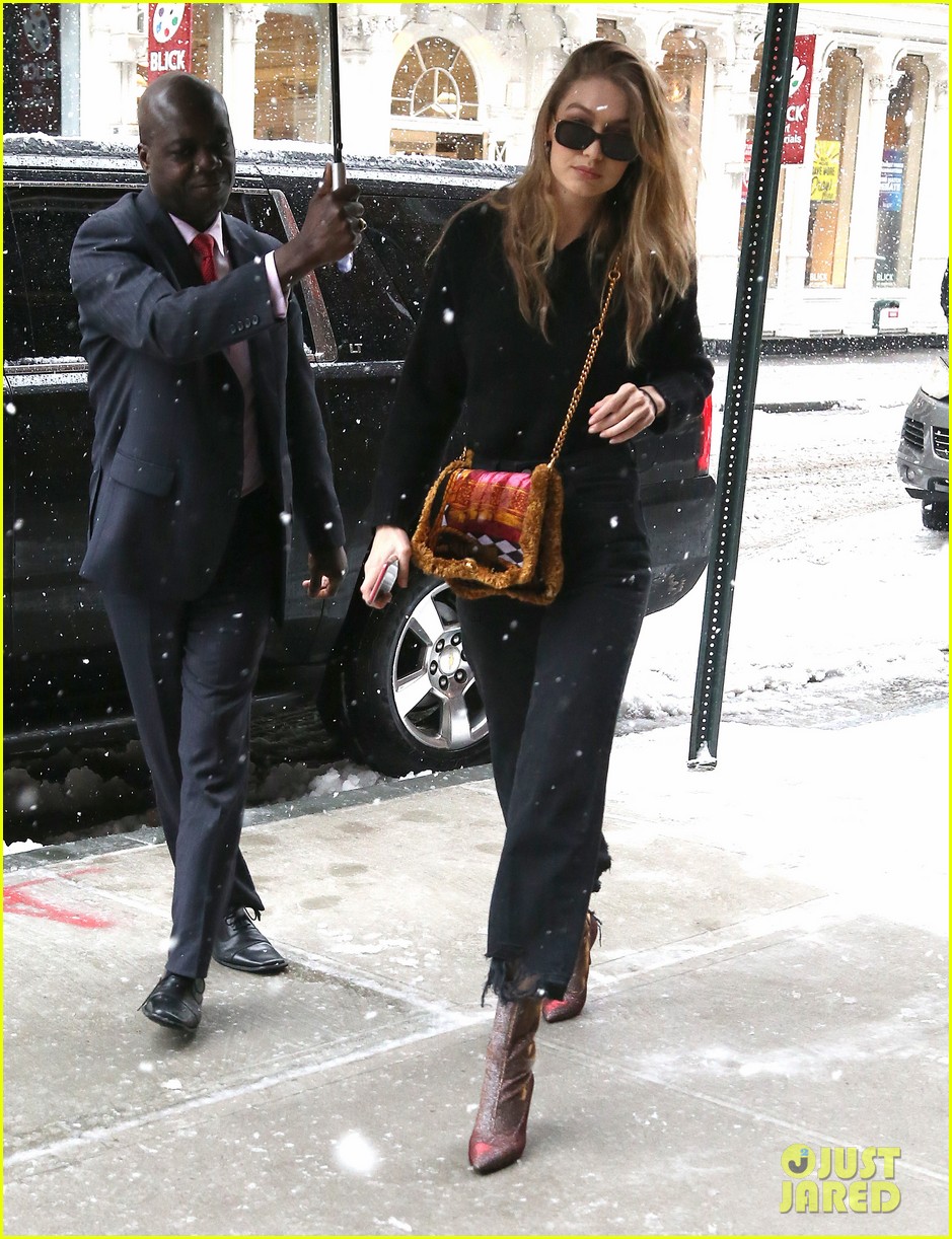 gigi hadid rocks colorful purse and boots while braving the snow 03