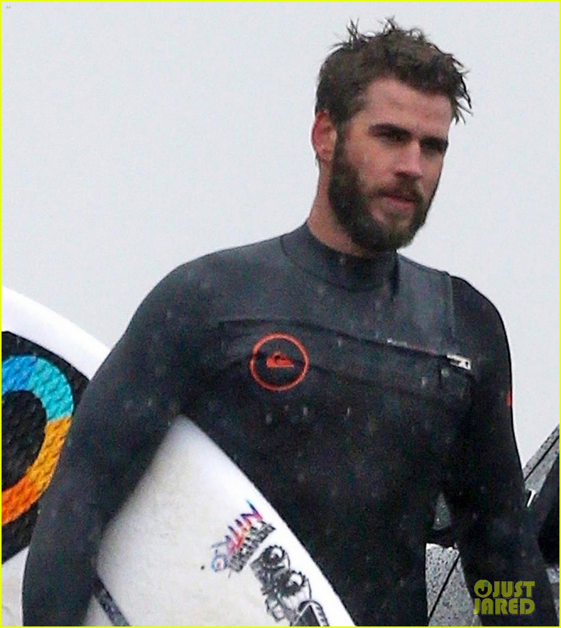 liam hemsworth and brother don their wetsuits while surfing in the rain 02