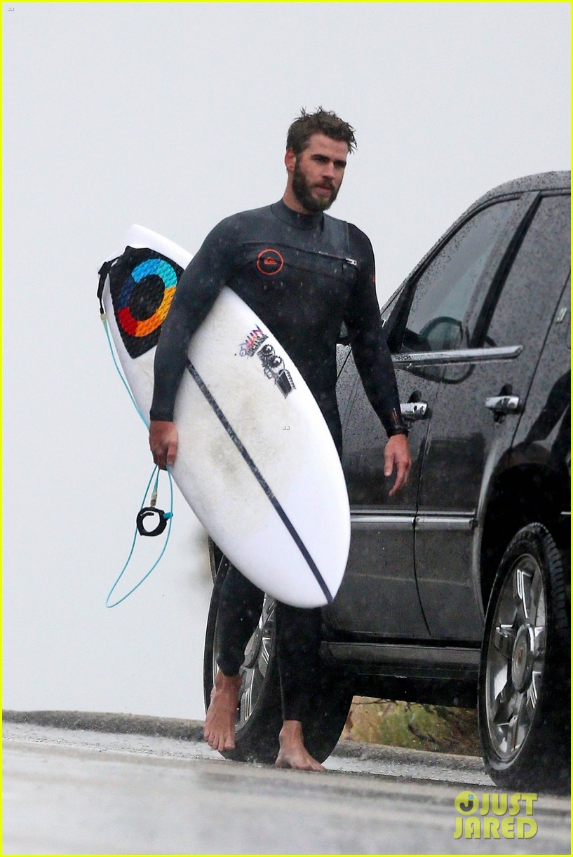 liam hemsworth and brother don their wetsuits while surfing in the rain 04