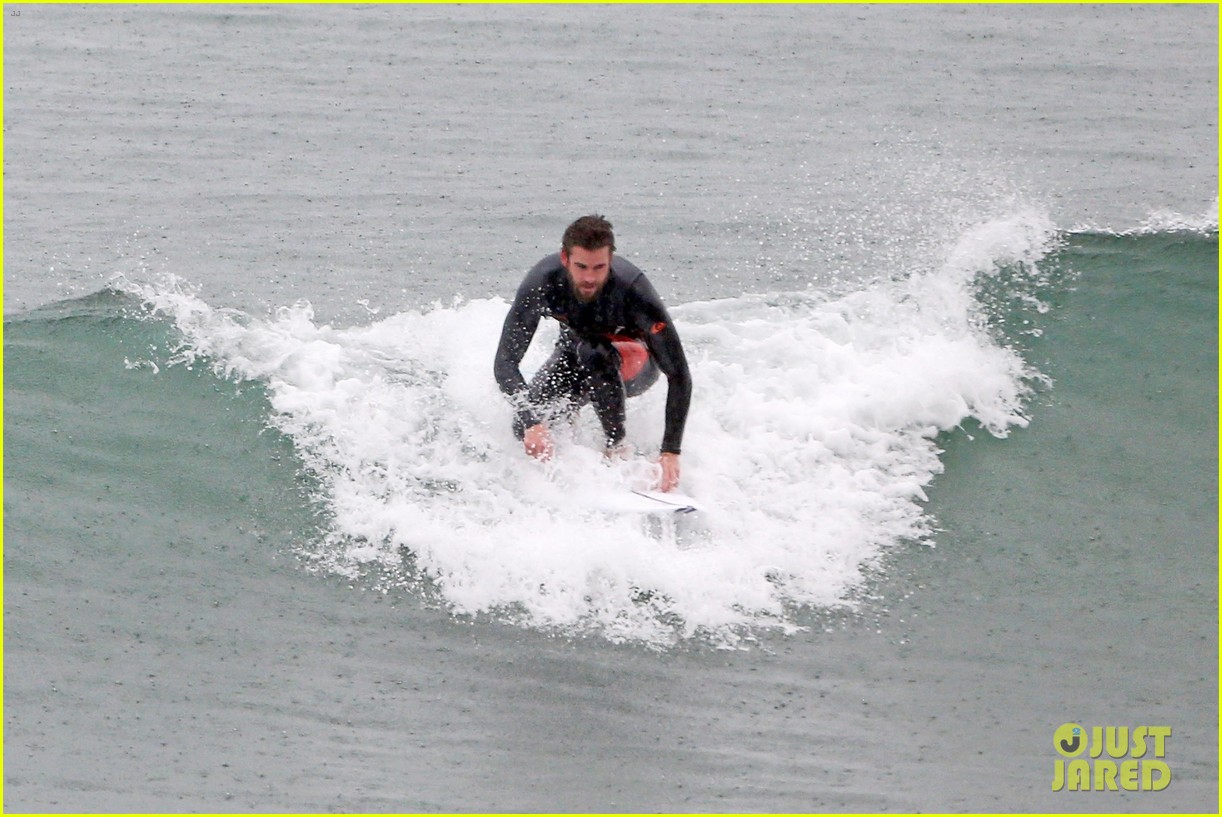 liam hemsworth and brother don their wetsuits while surfing in the rain 06