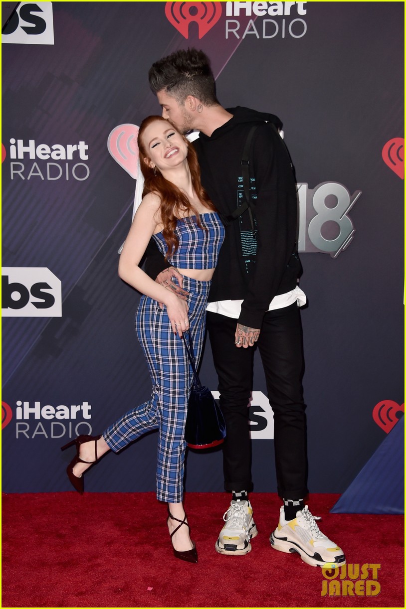 madelaine petsch gets a kiss from travis mills at iheart radio music awards 09
