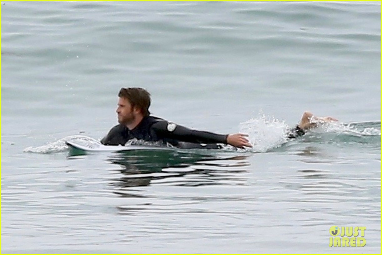 liam hemsworth bares hot bod while stripping out of wetsuit 17