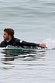 liam hemsworth bares hot bod while stripping out of wetsuit 17