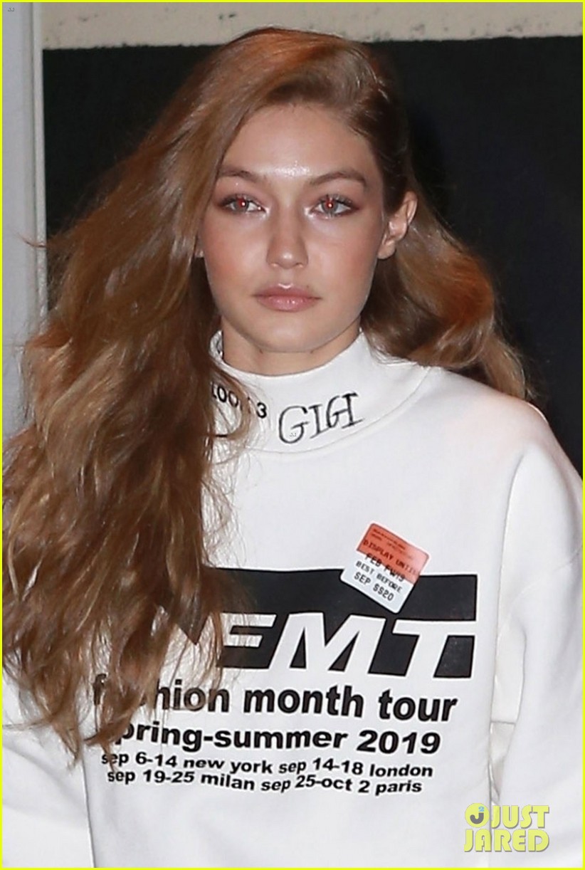 gigi hadid wears hair to one side shows name on sweater 05