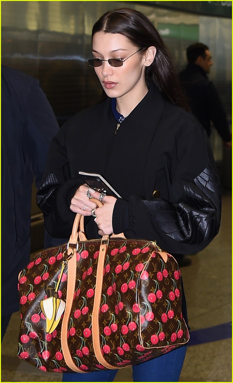 bella hadid jets from milan to nyc with cute cherry tote 02