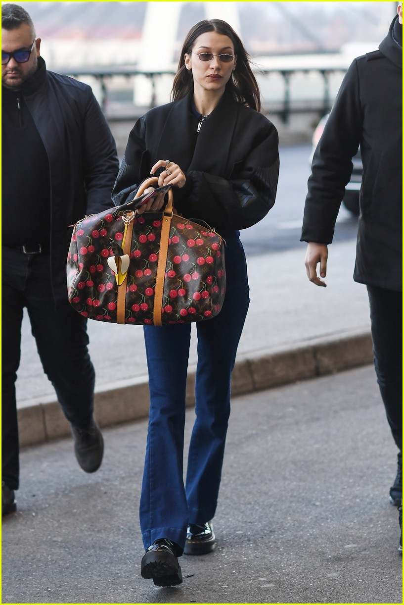 bella hadid jets from milan to nyc with cute cherry tote 03