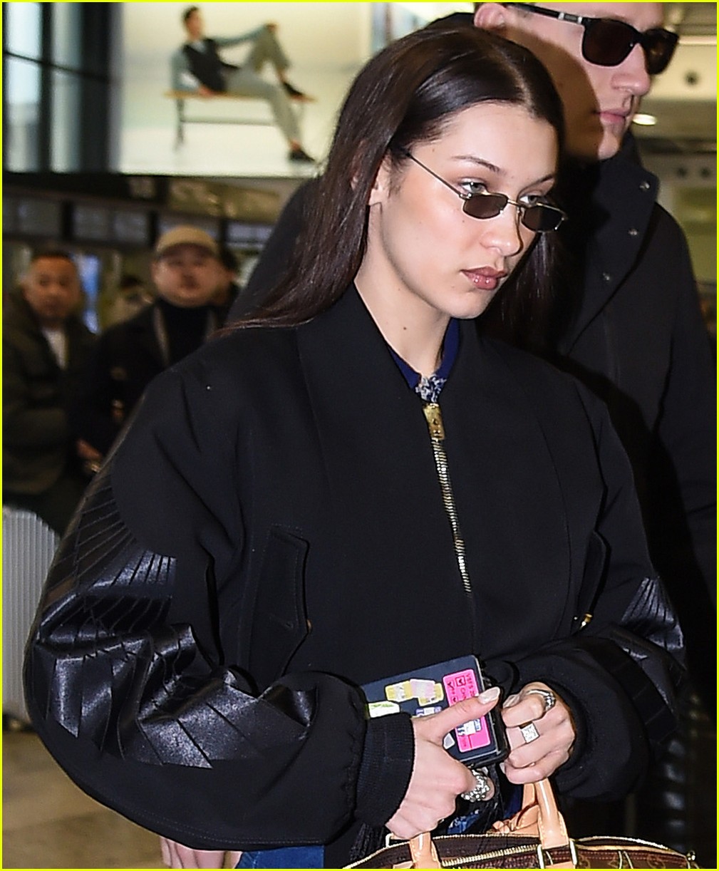bella hadid jets from milan to nyc with cute cherry tote 06