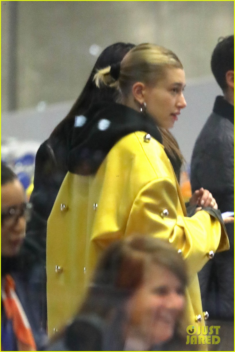 hailey bieber sports bright yellow coat for flight to paris 04
