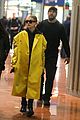 hailey bieber sports bright yellow coat for flight to paris 01