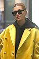 hailey bieber sports bright yellow coat for flight to paris 02