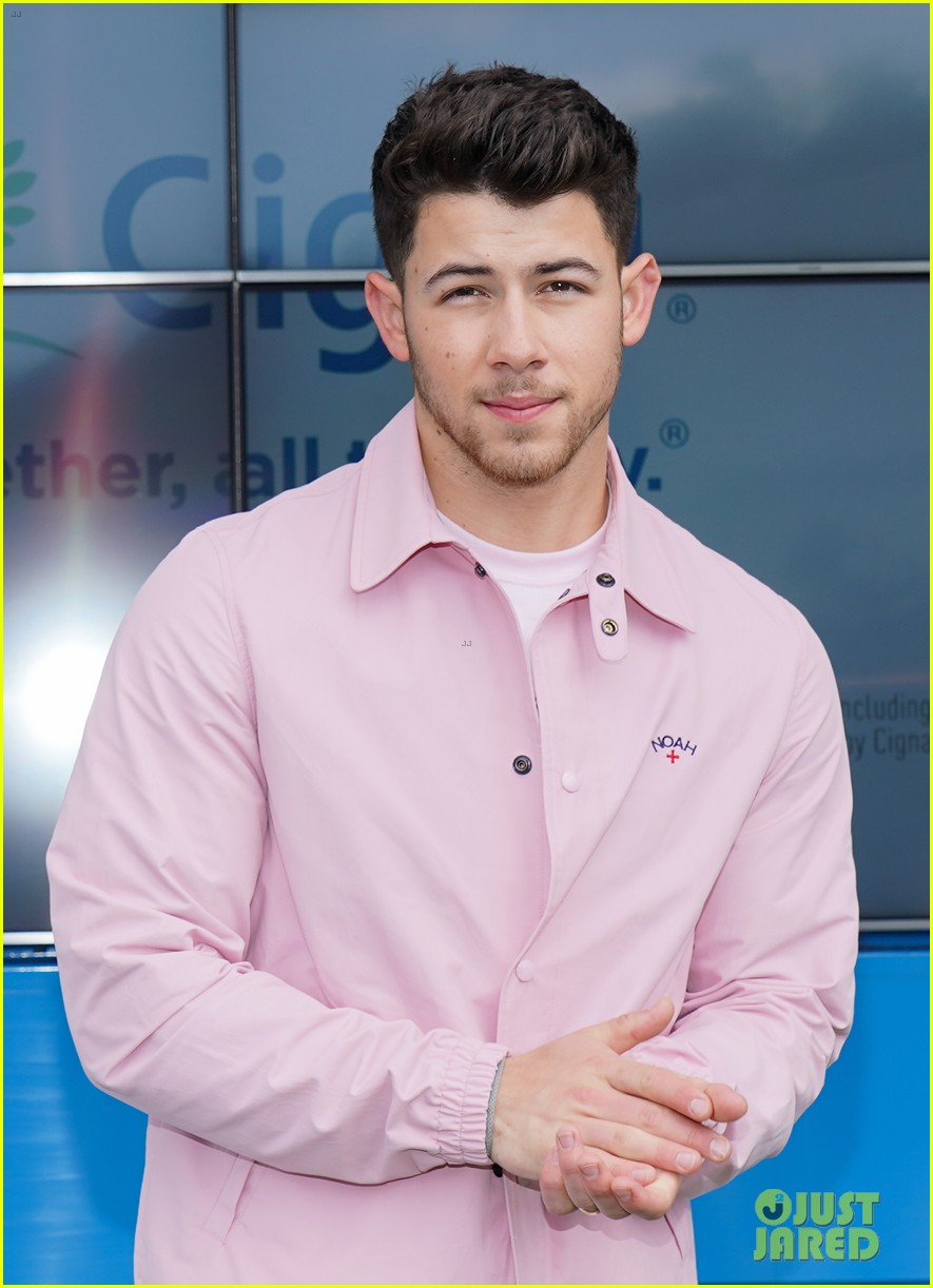 nick jonas cozies up to a puppy at cigna event 02