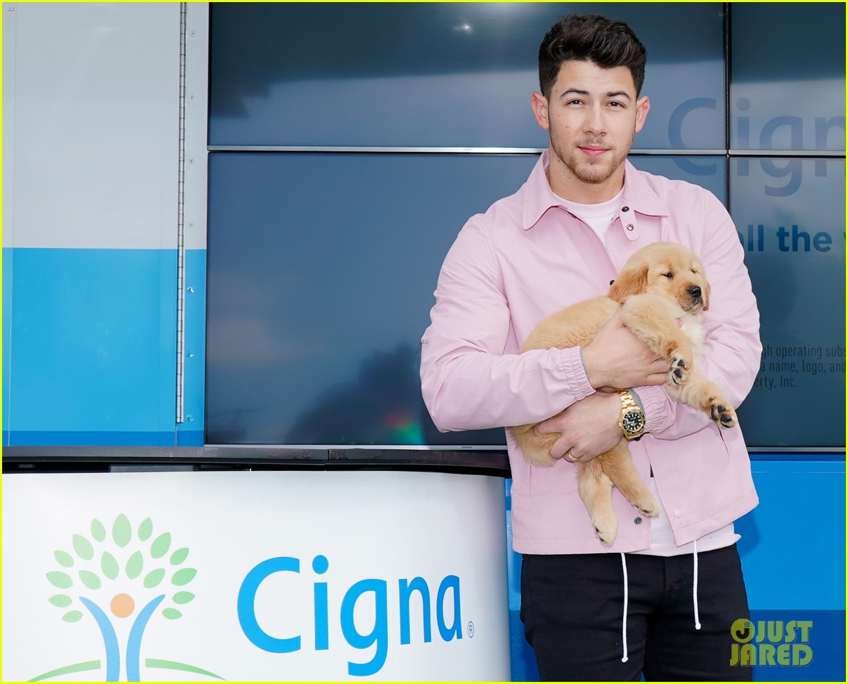 nick jonas cozies up to a puppy at cigna event 05