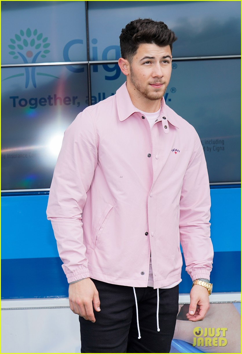 nick jonas cozies up to a puppy at cigna event 06