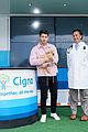 nick jonas cozies up to a puppy at cigna event 03