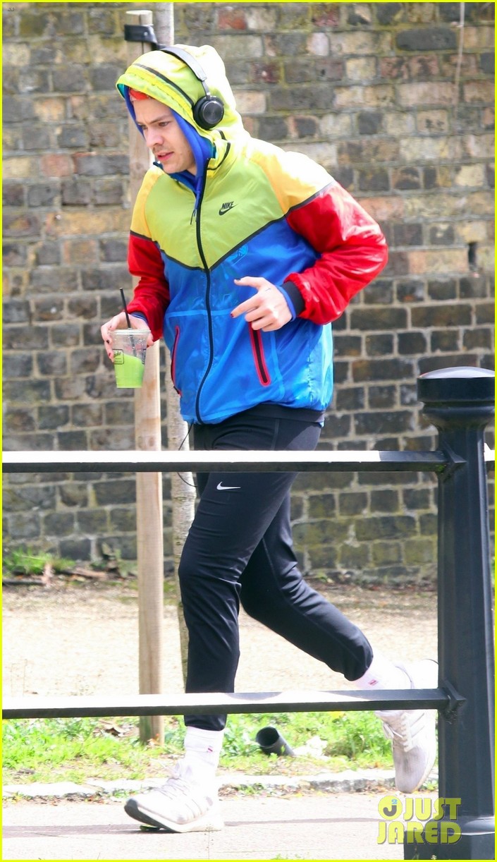 harry styles sports colorful jacket while jogging in london 01