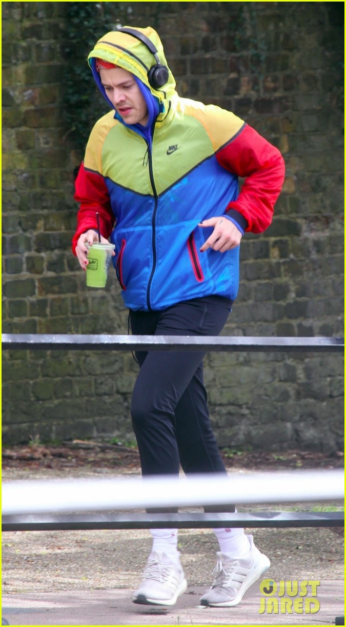 harry styles sports colorful jacket while jogging in london 03