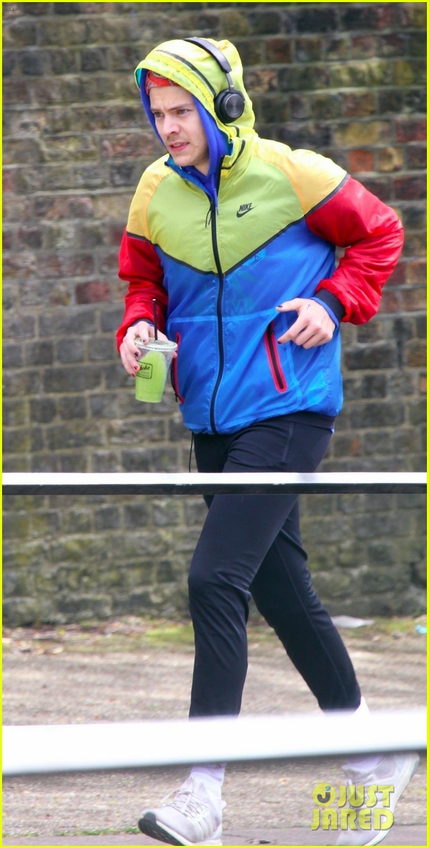 harry styles sports colorful jacket while jogging in london 05