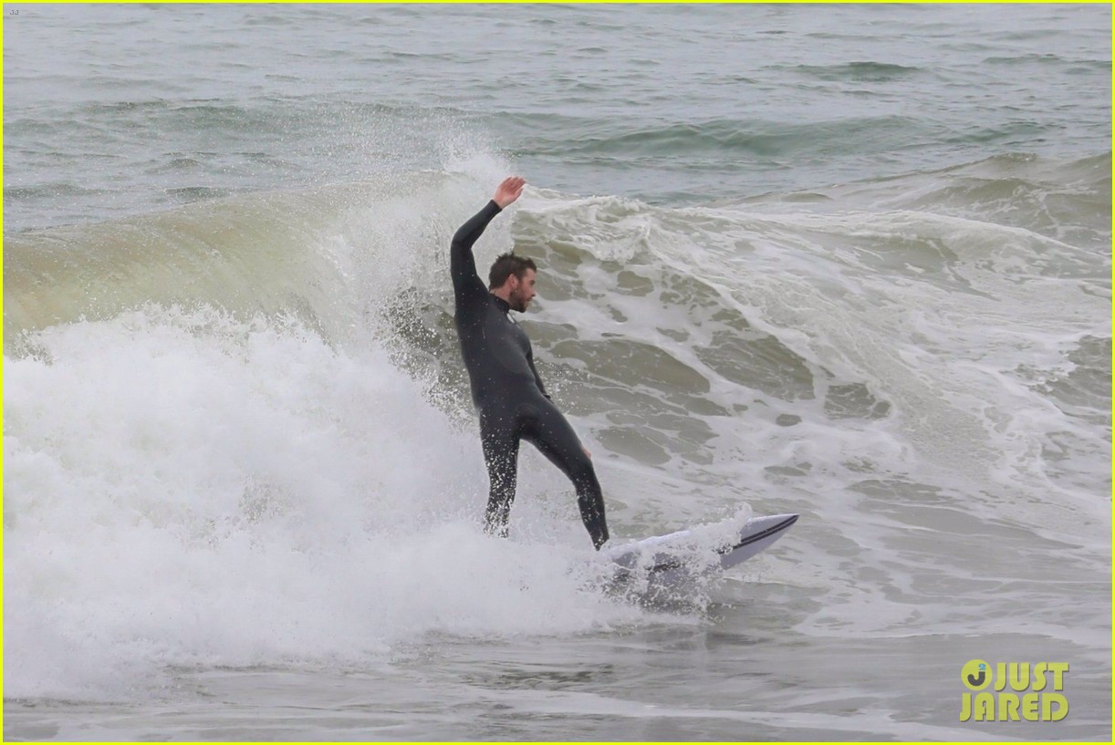 liam hemsworth strips out of his wetsuit after surfing 08