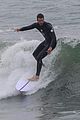 liam hemsworth strips out of his wetsuit after surfing 01