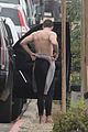 liam hemsworth strips out of his wetsuit after surfing 34