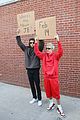 justin bieber with dude with sign 01