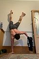 tom holland shows off muscular body while putting on a shirt while doing handstand 04