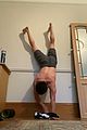 tom holland shows off muscular body while putting on a shirt while doing handstand 05