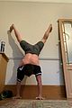 tom holland shows off muscular body while putting on a shirt while doing handstand 08