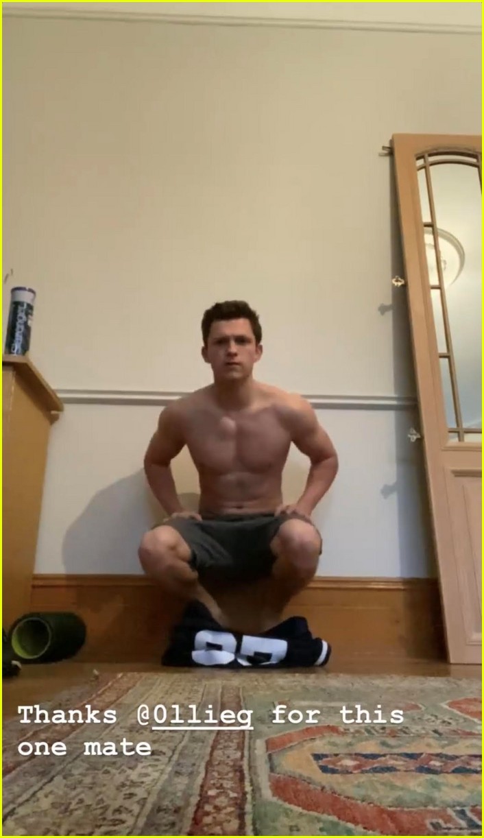 tom holland shows off muscular body while putting on a shirt while doing handstand 01