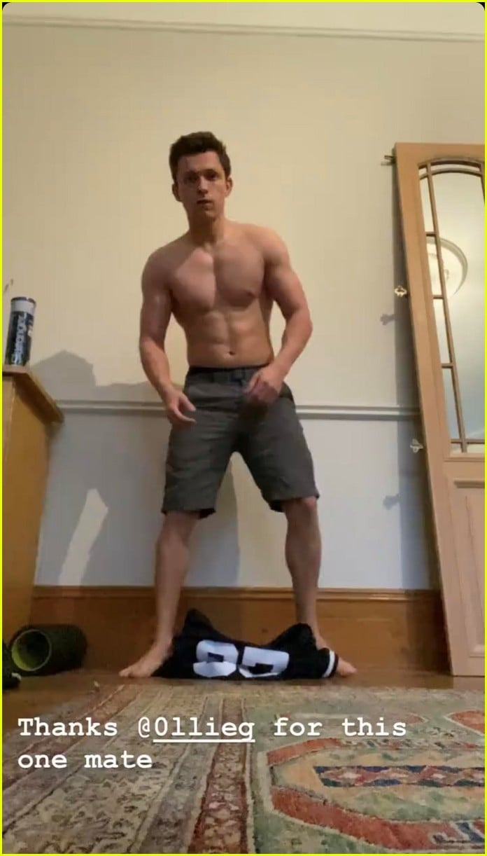 tom holland shows off muscular body while putting on a shirt while doing handstand 02