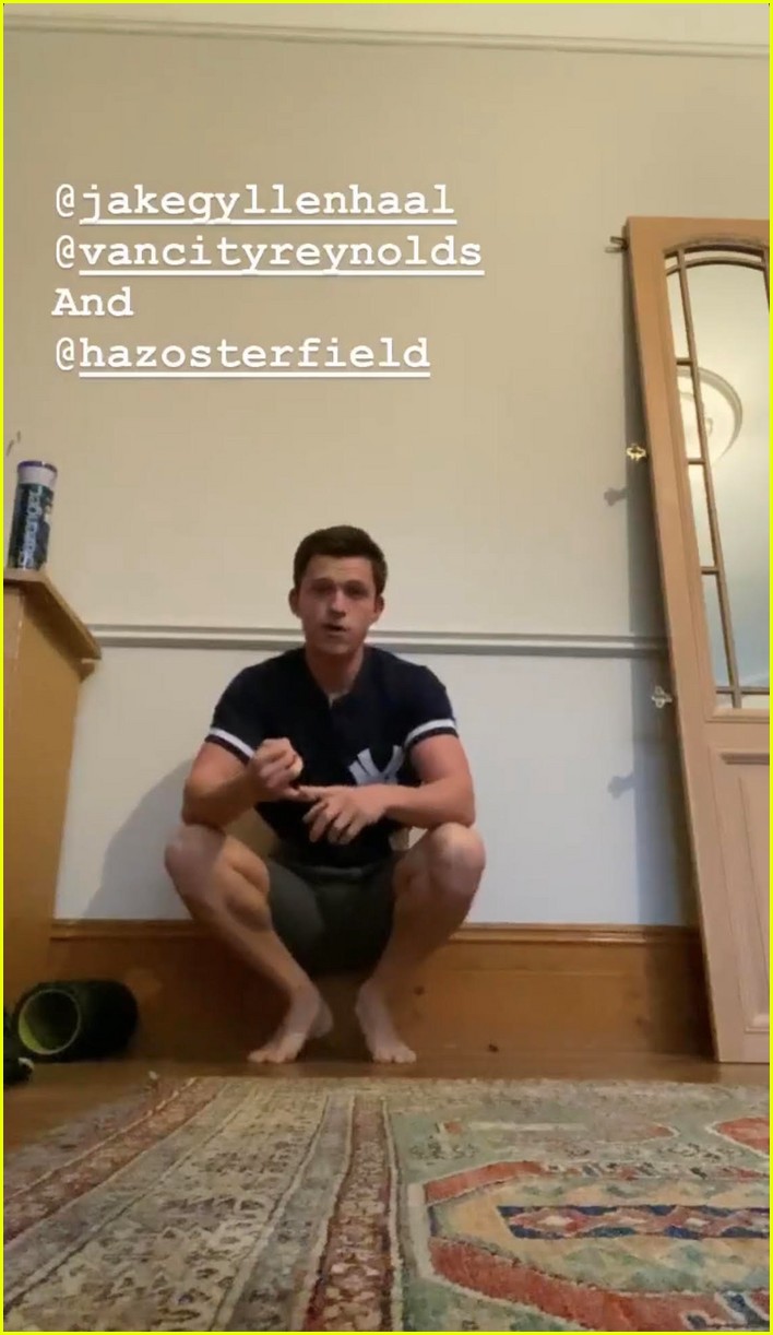 tom holland shows off muscular body while putting on a shirt while doing handstand 10