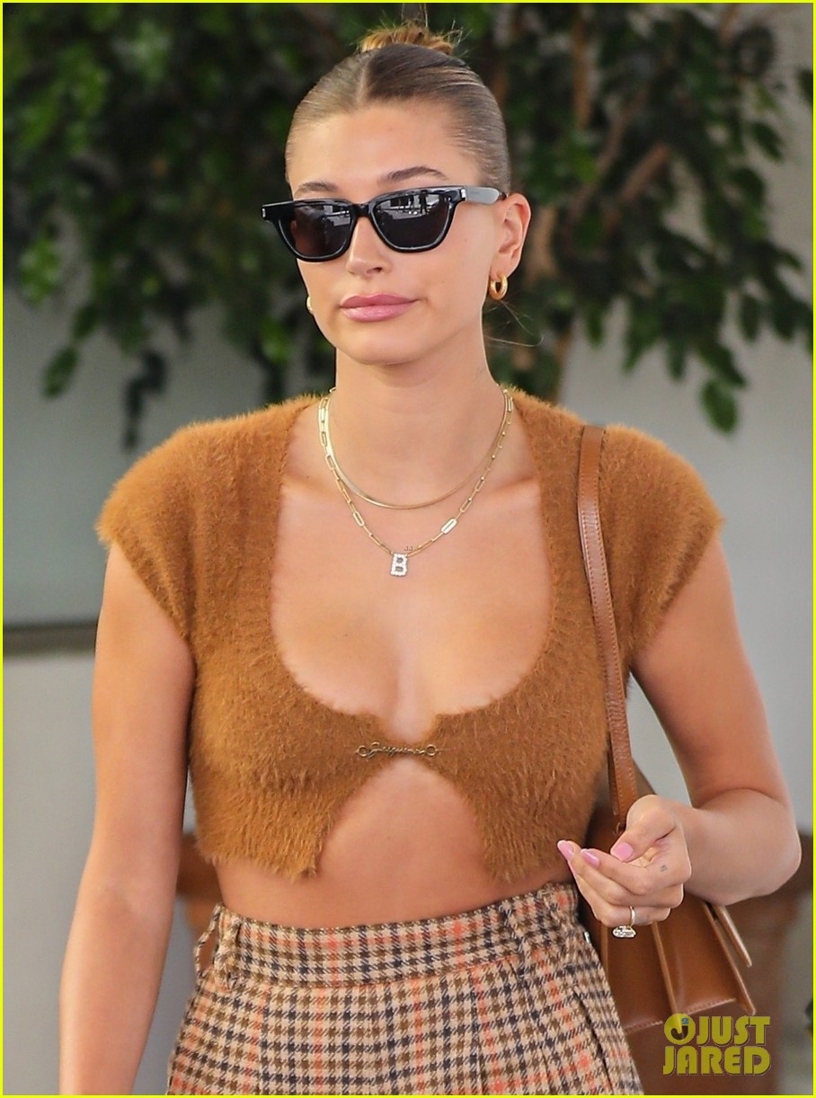 hailey bieber shows off fit figure in crop top sweater plaid pants 01