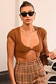hailey bieber shows off fit figure in crop top sweater plaid pants 05