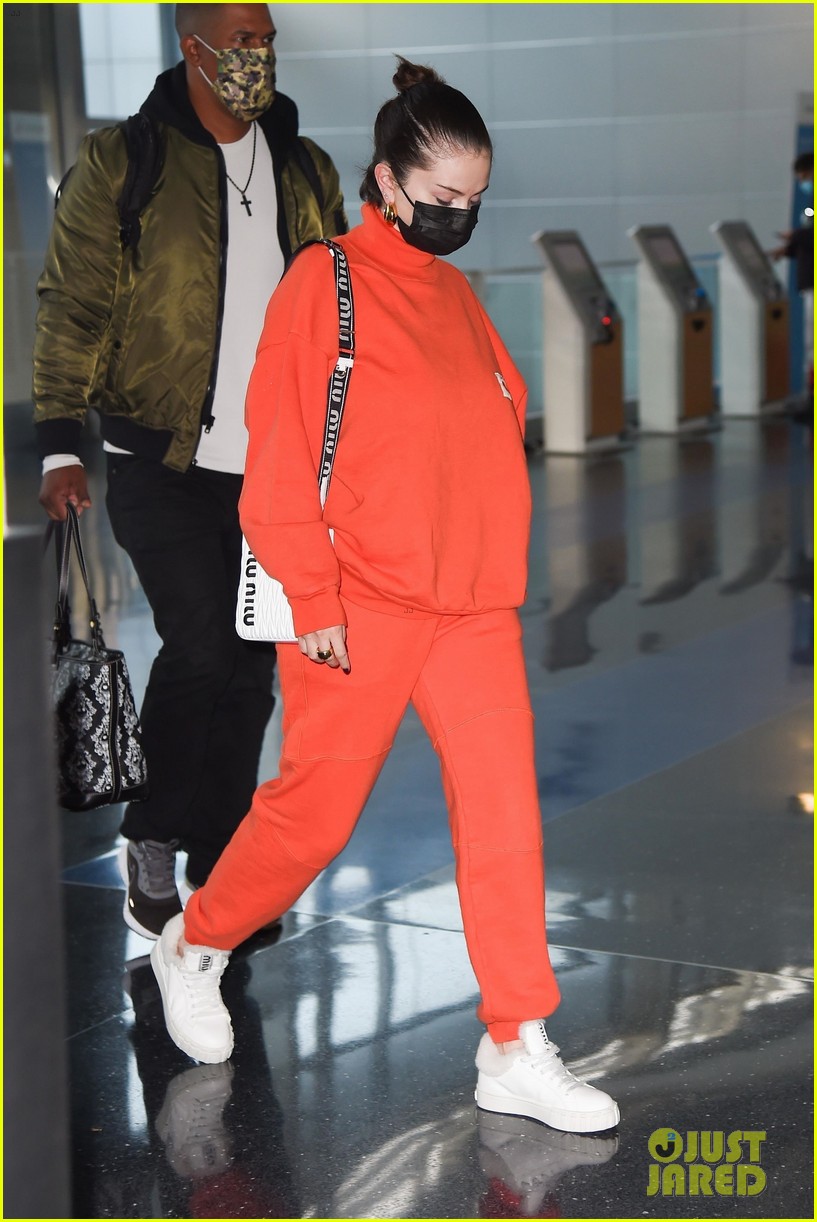 selena gomez orange tracksuit airport arrival 15