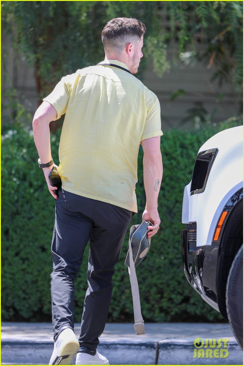 nick jonas sports bright yellow celine shirt for afternoon meeting 08