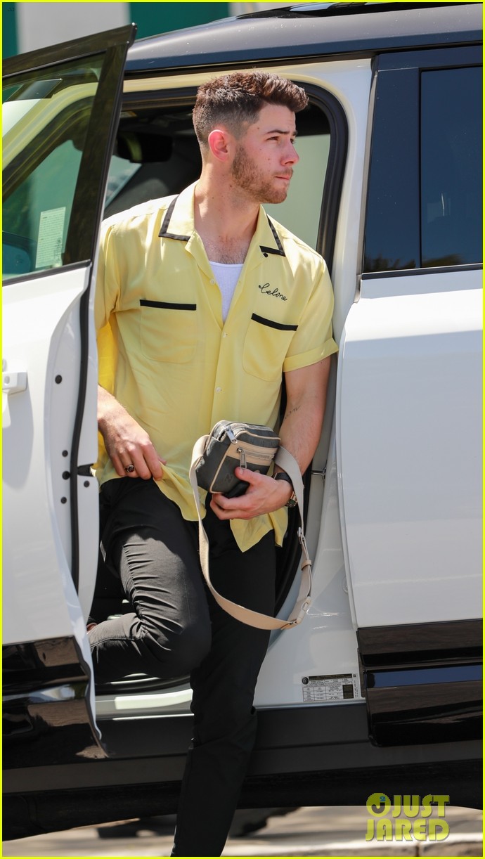 nick jonas sports bright yellow celine shirt for afternoon meeting 12