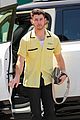 nick jonas sports bright yellow celine shirt for afternoon meeting 06